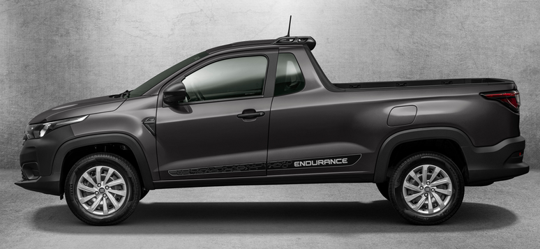 Side view of a dark gray pickup truck with the word 'ENDURANCE' displayed on the side, parked against a textured gray background.