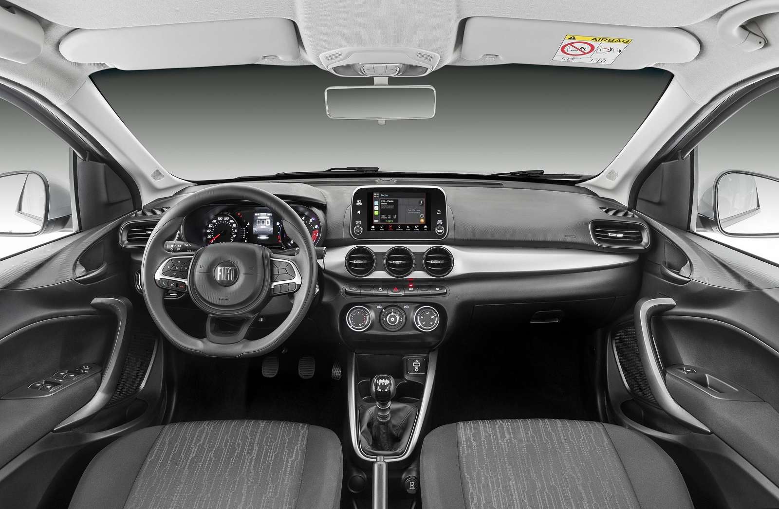 Interior view of a Fiat car dashboard, highlighting the steering wheel, infotainment system, climate controls, and seating.