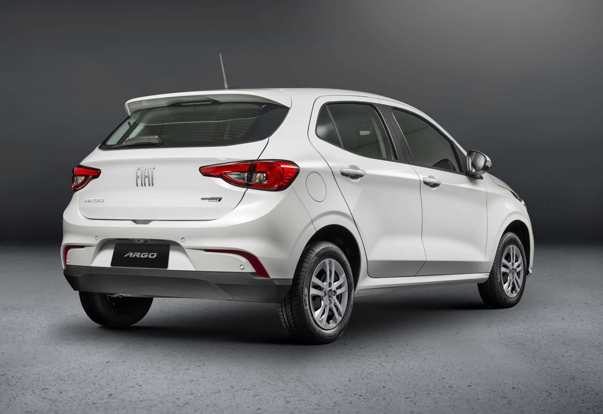 White Fiat Argo hatchback viewed from the rear, showcasing its sleek design and logo.