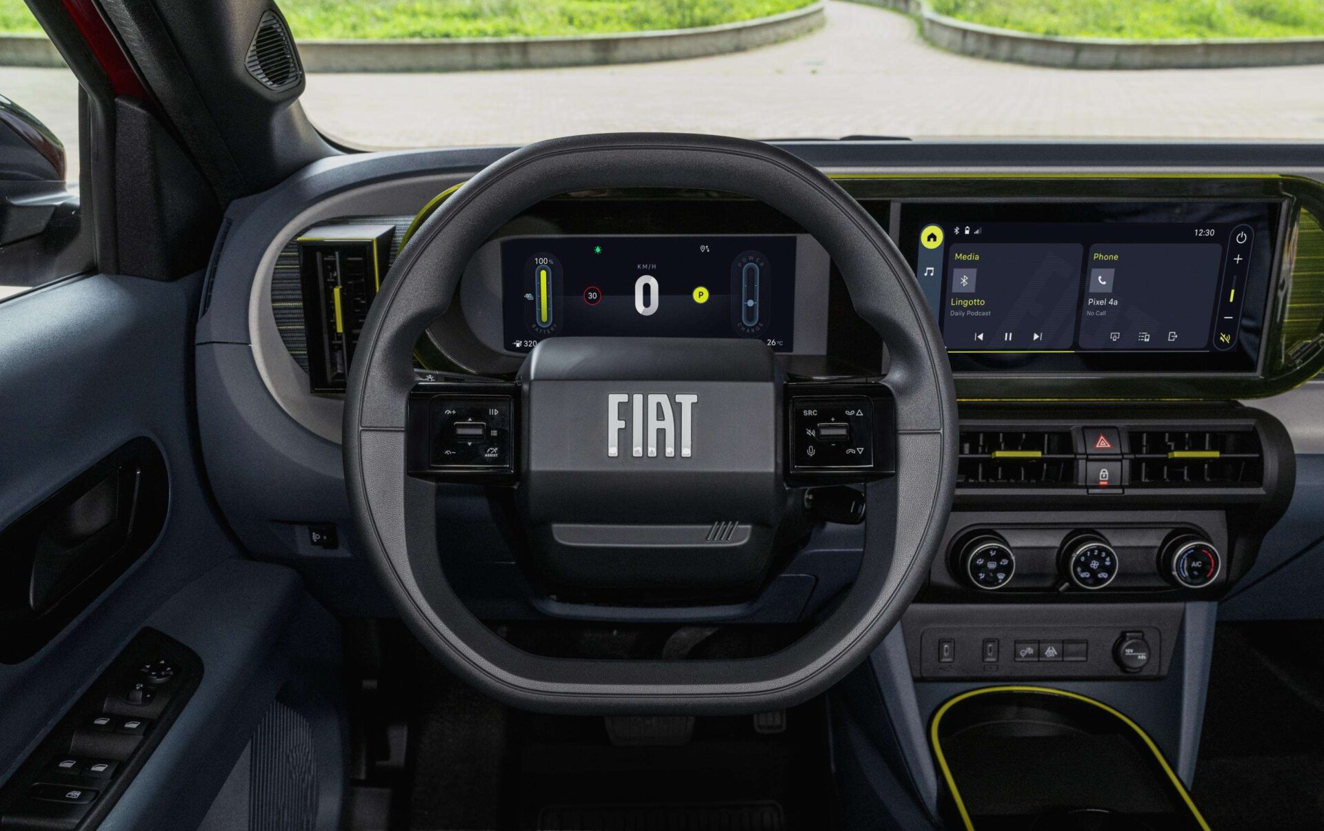 Interior view of a Fiat vehicle showcasing the steering wheel with the Fiat logo, digital dashboard displays, and central multimedia screen.