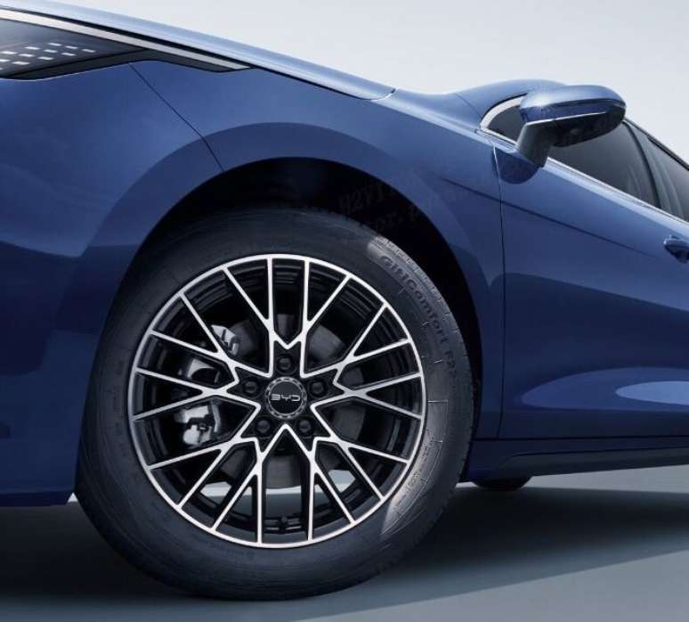 Close-up of a blue car's wheel, featuring a stylish black and silver alloy rim with a modern design.
