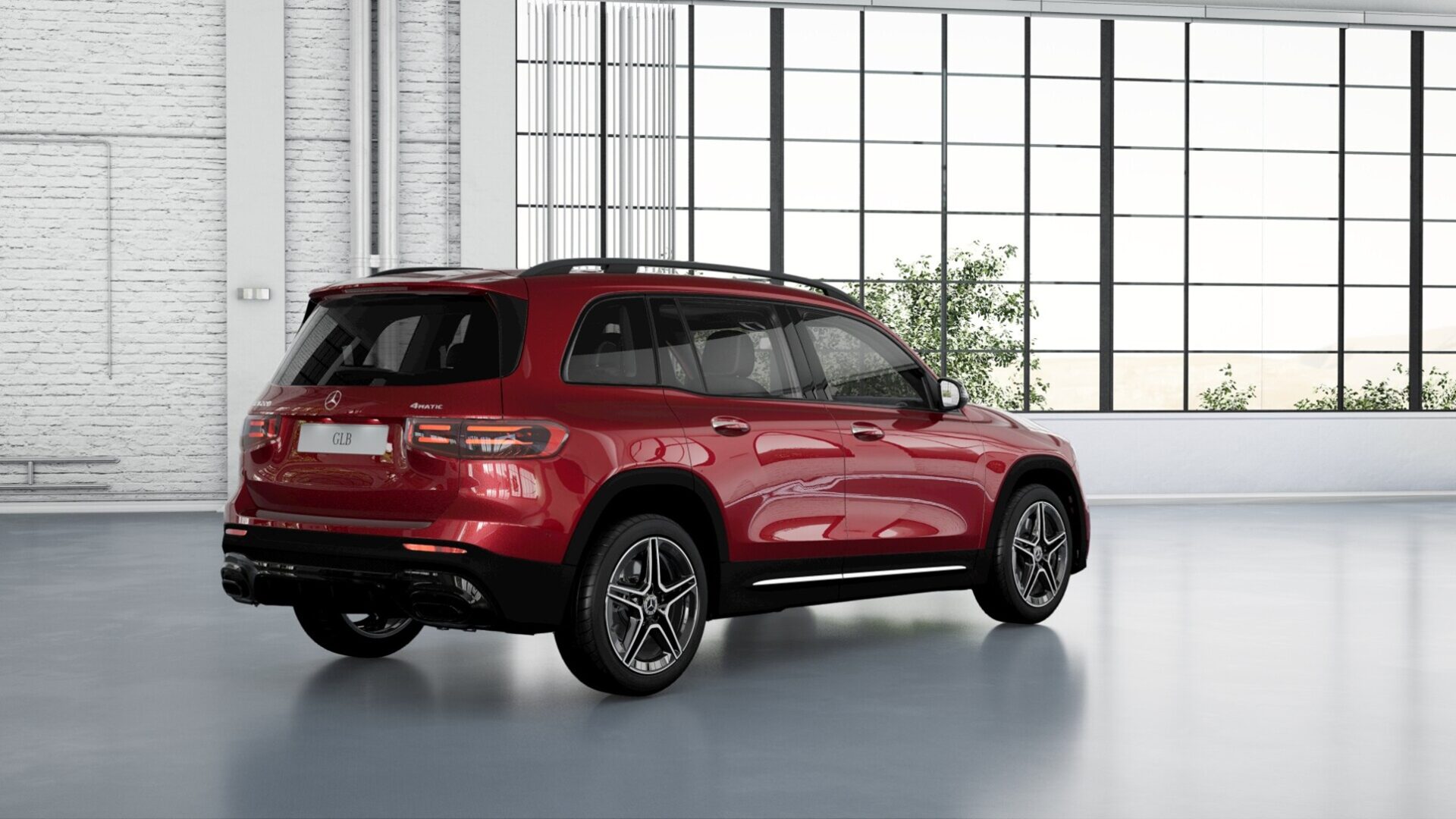 A red Mercedes-Benz GLB SUV displayed in a modern indoor environment with large windows allowing natural light.