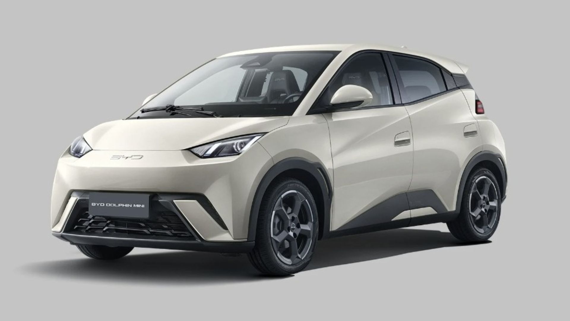 Carro elétrico BYD Dolphin Mini na cor creme, com design moderno e aro de roda esportivo.