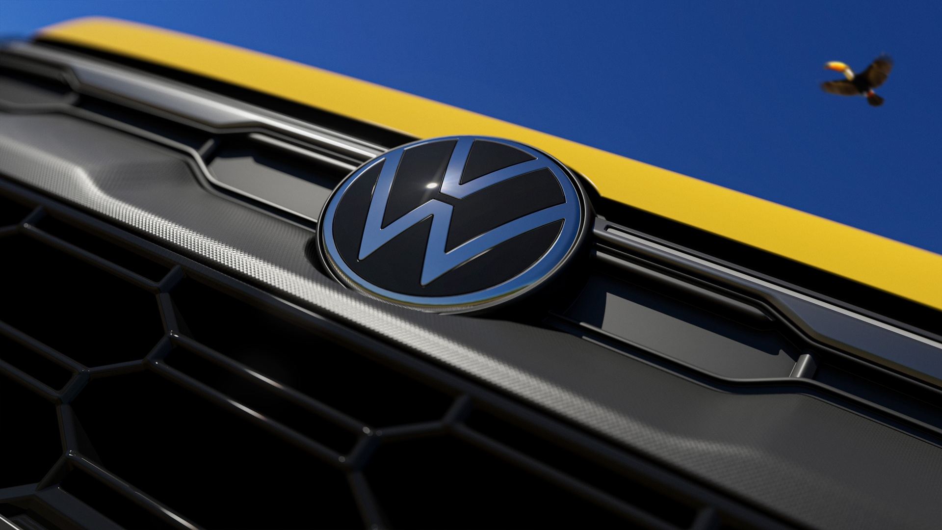 Close-up of a Volkswagen logo on a car's front grille with a bright blue sky in the background.
