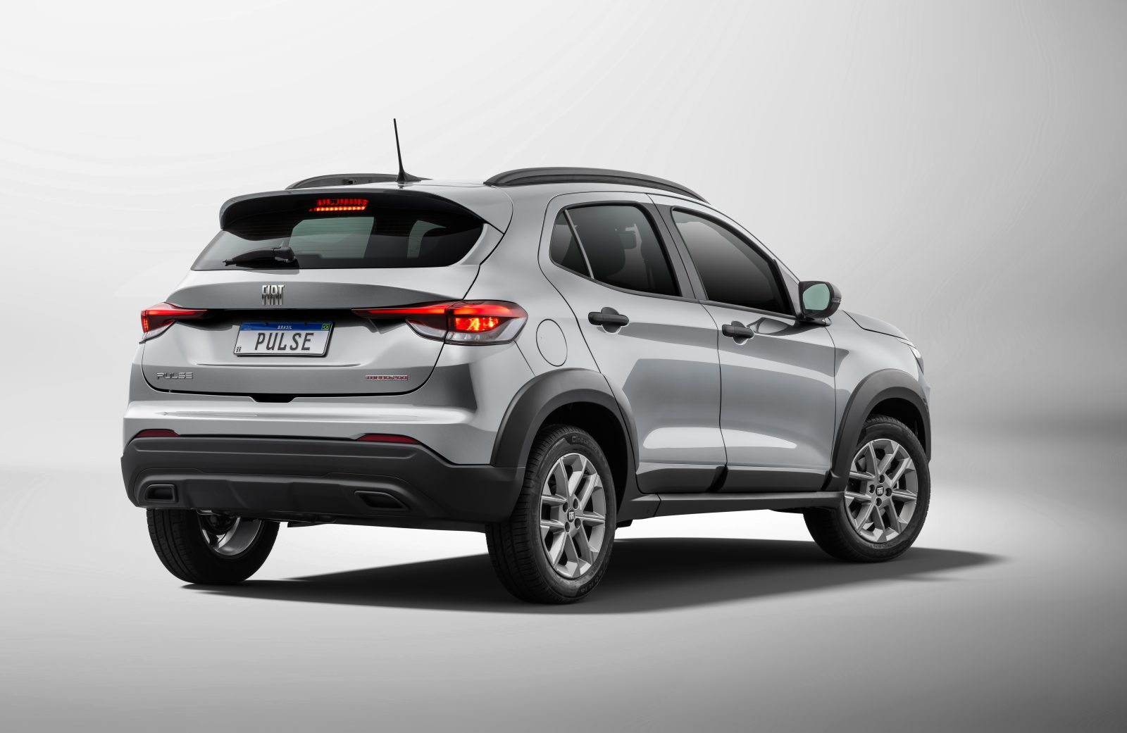 Rear view of a silver Fiat Pulse SUV against a light background.