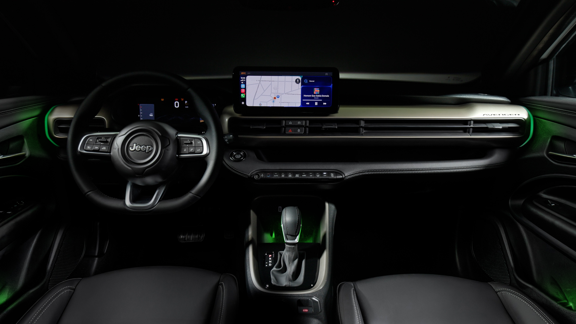 Interior of a Jeep car featuring a steering wheel with Jeep branding, a digital display showing navigation, and various control buttons. The seating is black leather with ambient lighting in green.