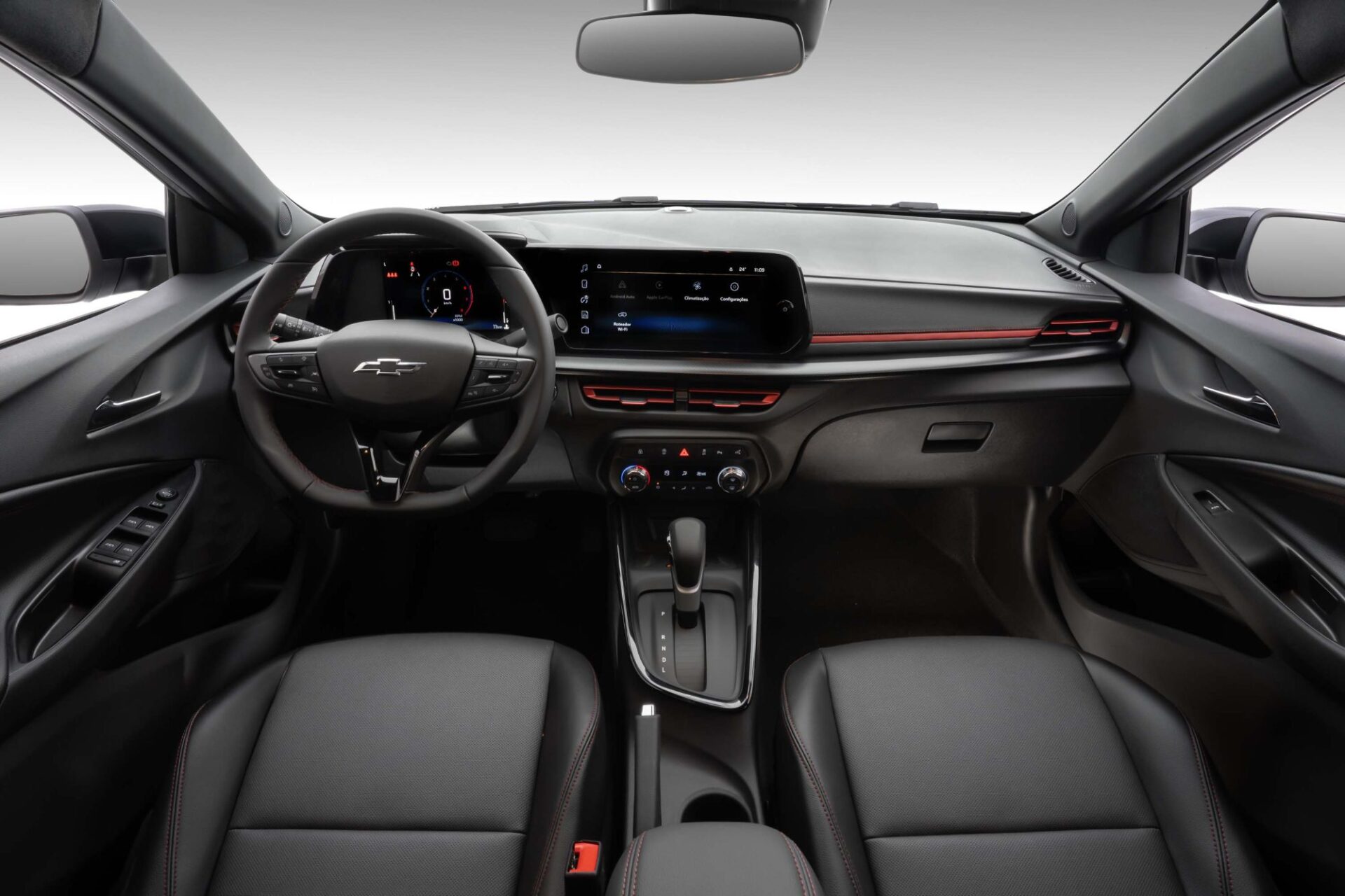 Interior view of a Chevrolet car showcasing the dashboard, steering wheel, and front seats. The dashboard features a digital display and modern controls.