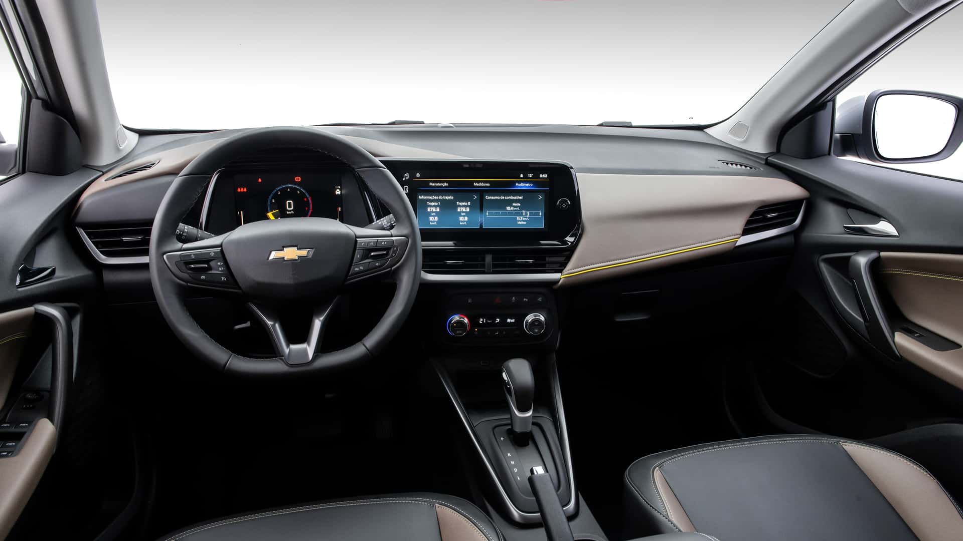 Interior de um carro da Chevrolet, mostrando o painel, volante e tela de controle central.