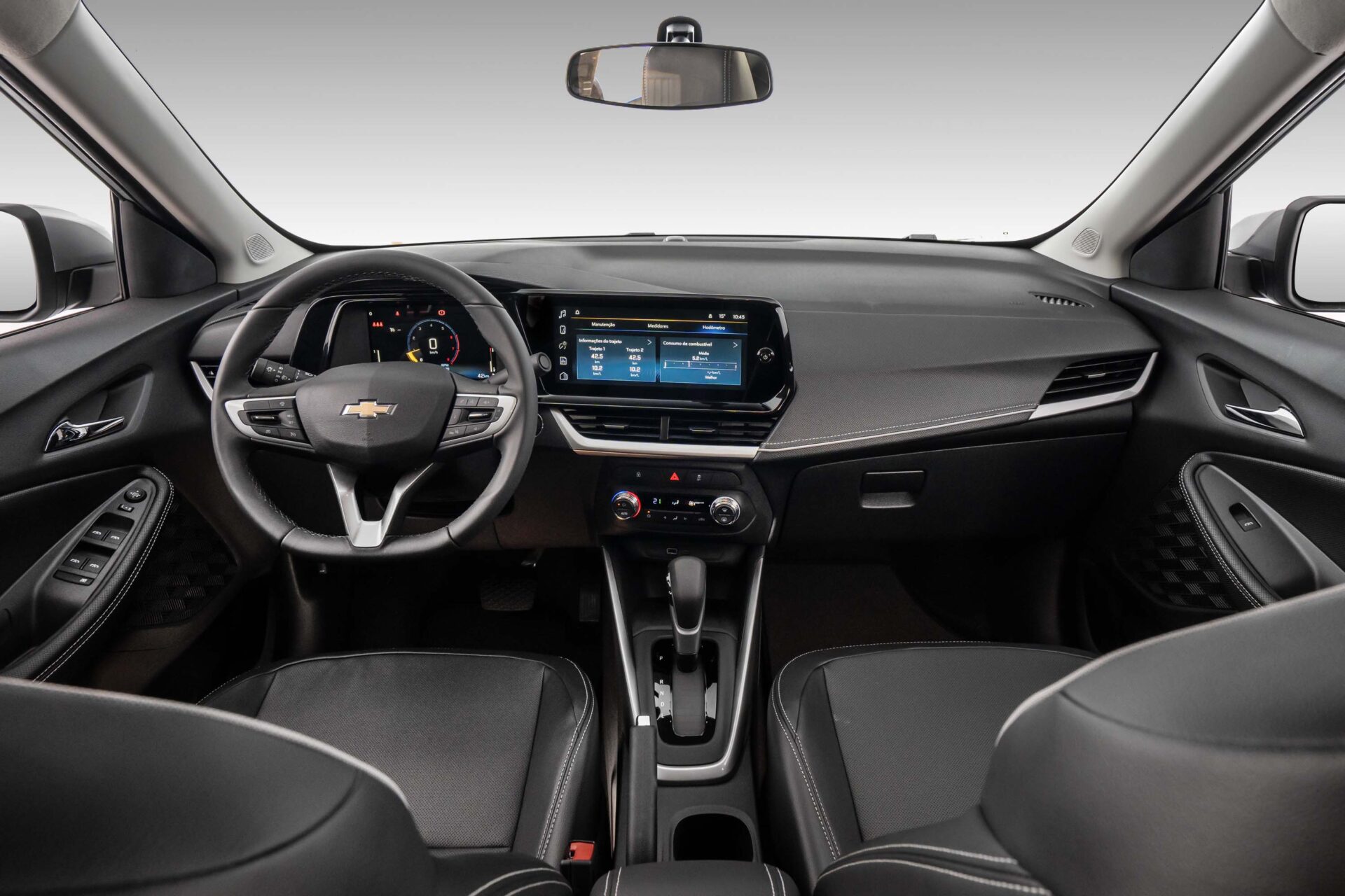 Interior view of a modern Chevrolet car showing the steering wheel, dashboard, and infotainment system.