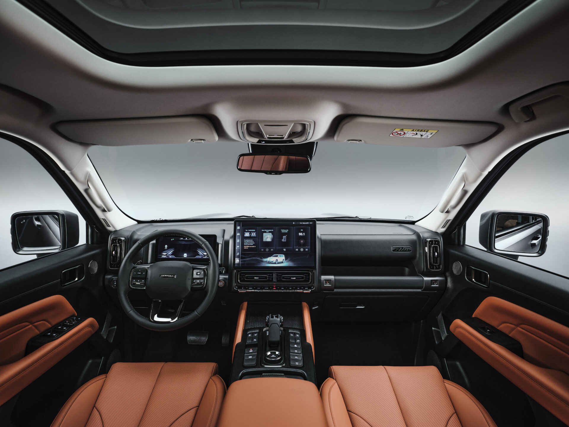 Interior view of a modern vehicle showcasing a sleek dashboard, advanced infotainment system, and leather seating in a spacious cabin.