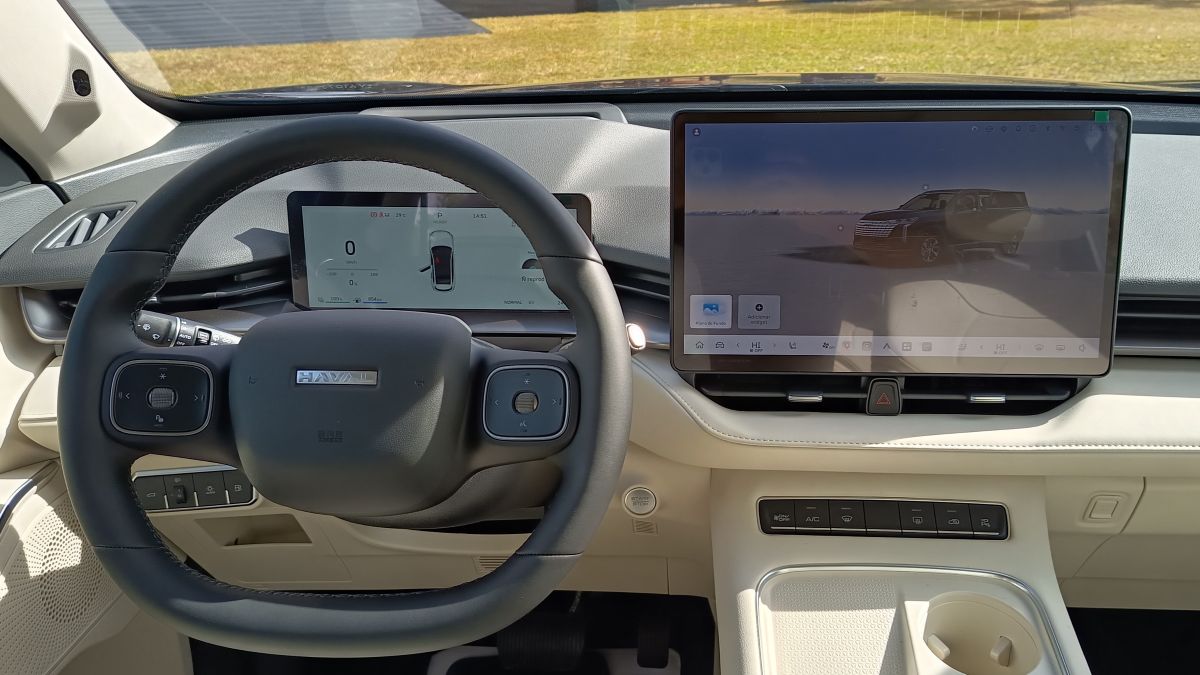 Interior view of a modern car dashboard featuring a steering wheel, digital display, and infotainment screen.