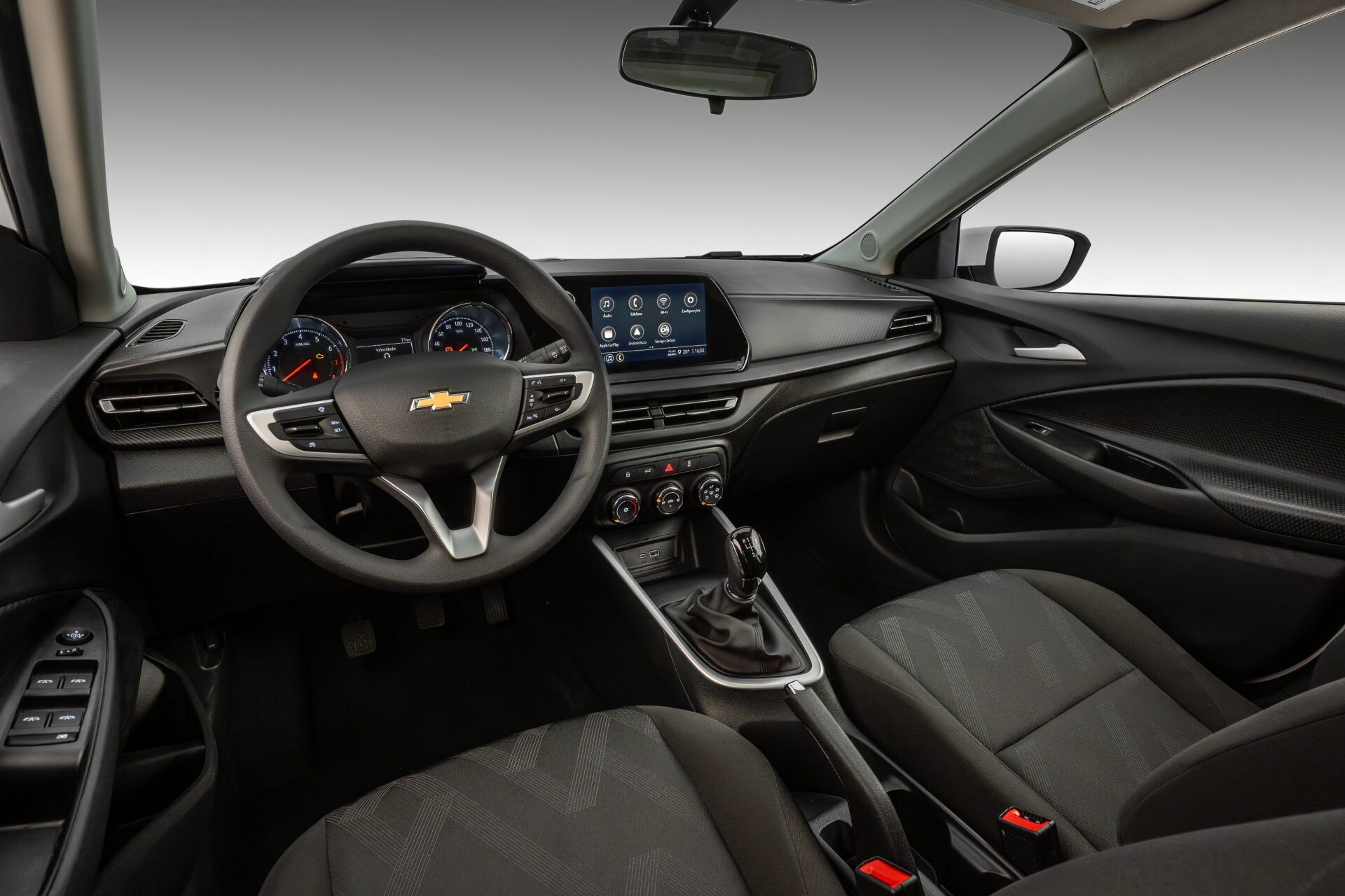 Interior view of a Chevrolet car featuring a modern dashboard, steering wheel, touchscreen display, and comfortable seating.