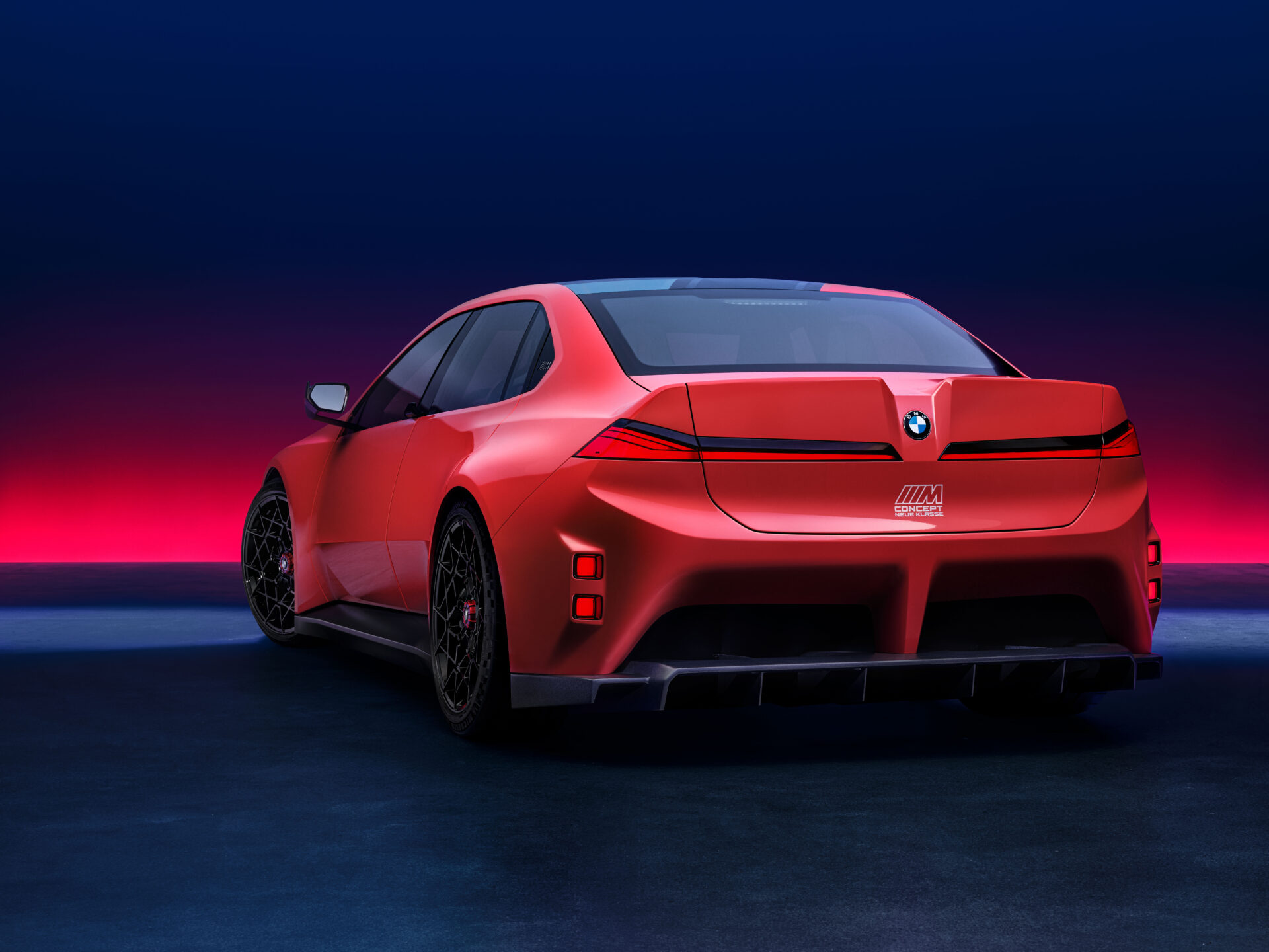 A rear view of a red BMW car with an aerodynamic design, featuring sleek lines and a sporty rear spoiler, set against a gradient blue and pink background.
