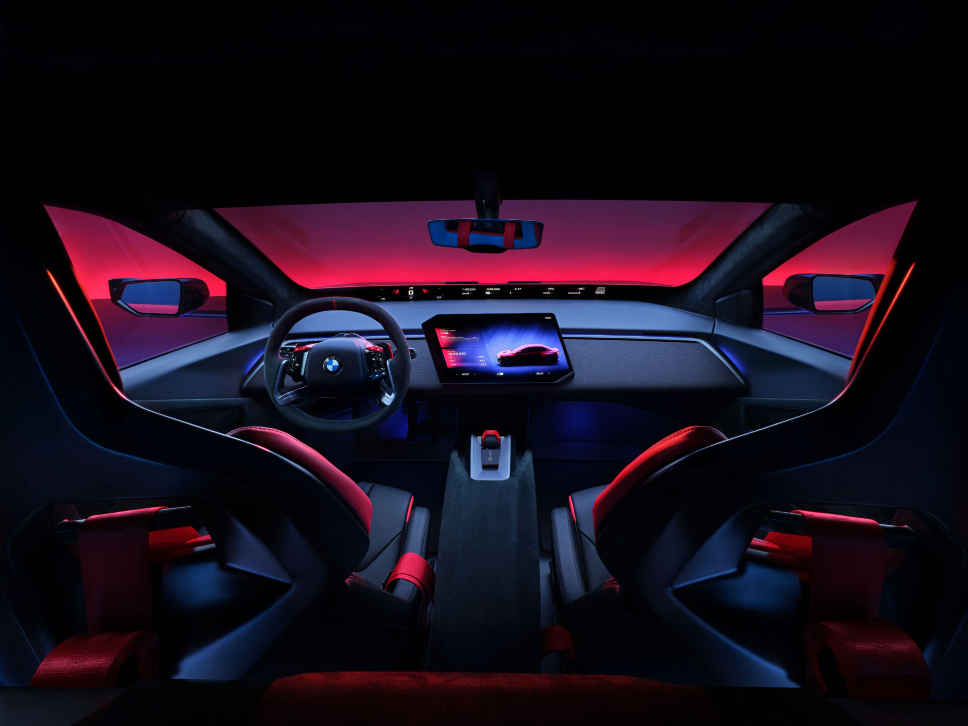 Futuristic car interior featuring a steering wheel, a large digital display, and vibrant ambient lighting in shades of red and blue.