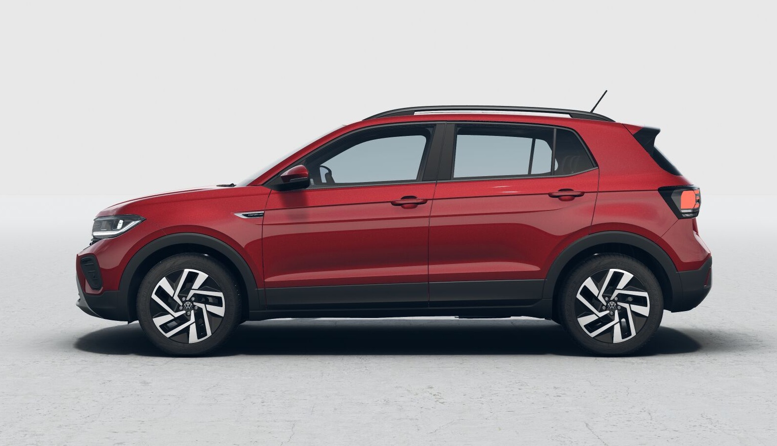A red compact SUV viewed from the side, showcasing its sleek design and modern features.