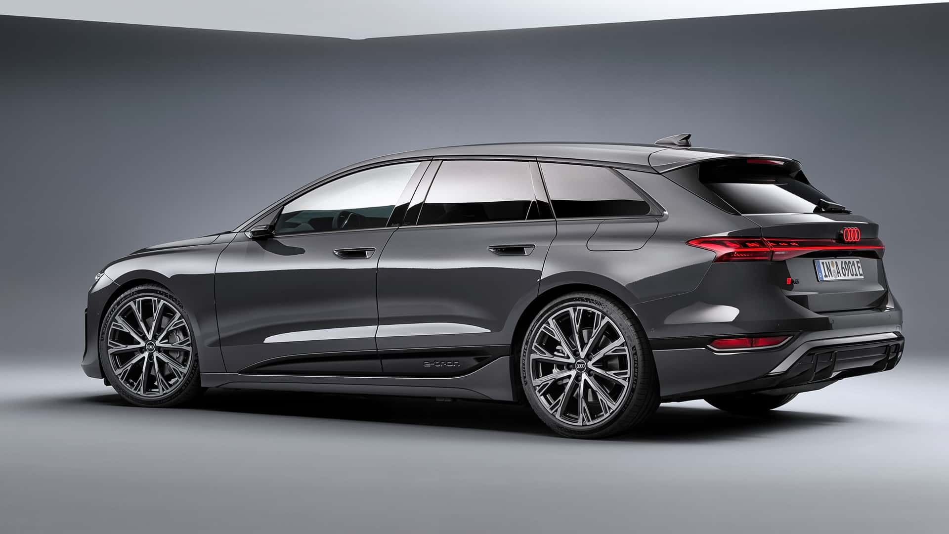 Side view of a sleek gray Audi wagon, showcasing its sporty design and distinctive features.