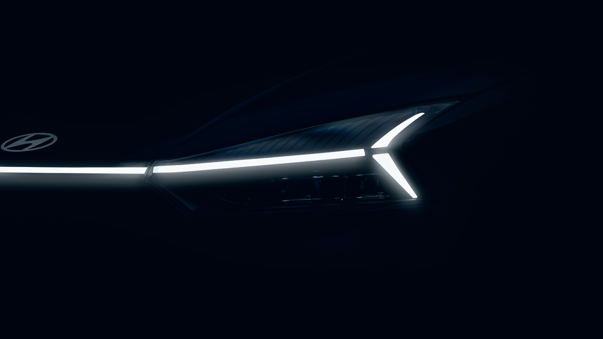 Close-up of a car front with illuminated LED lights against a dark background.