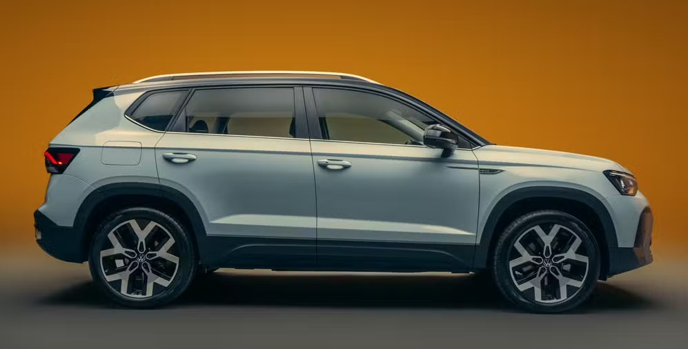 A modern SUV in profile view, featuring a sleek design and alloy wheels, set against a gradient orange background.