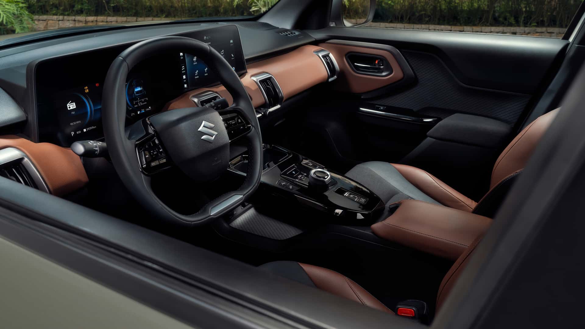 Interior view of a modern car featuring a stylish dashboard, a multifunction steering wheel, and leather-upholstered seats.