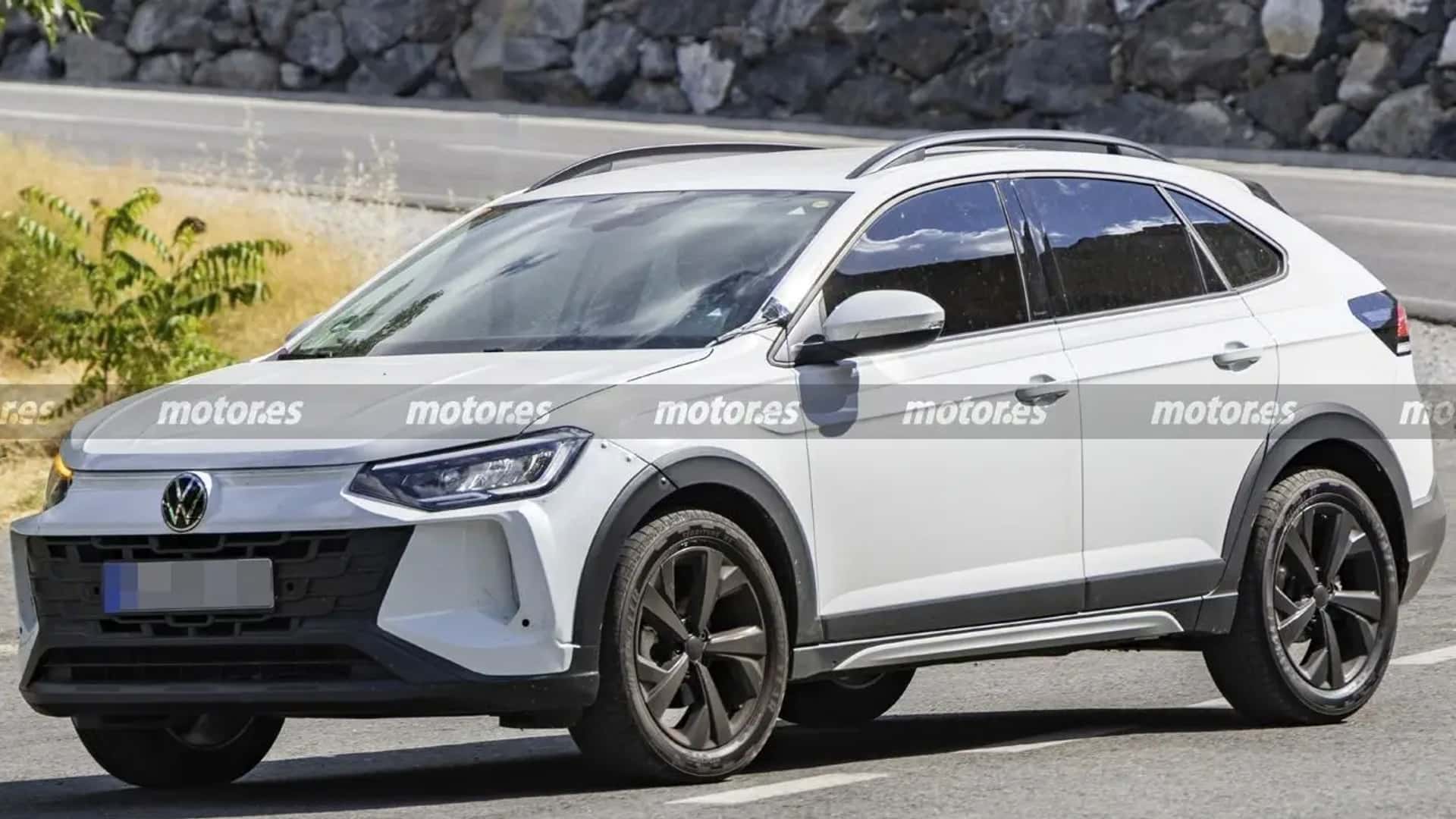A white Volkswagen SUV with a sleek design parked on a road, featuring black alloy wheels and tinted windows.