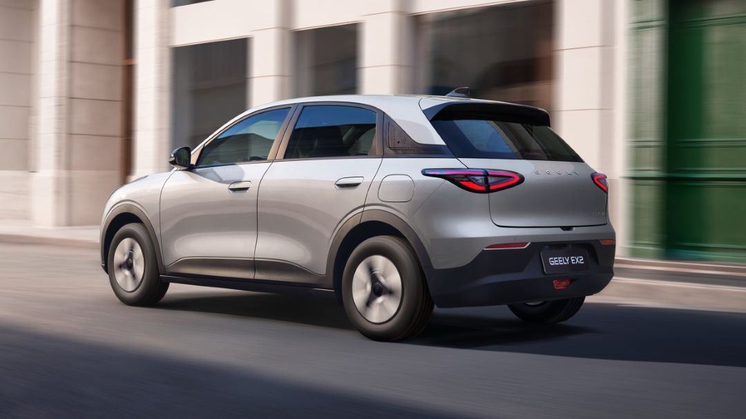 Carro utilitário esportivo Geely EX2 prateado em movimento, com foco na traseira e lateral.