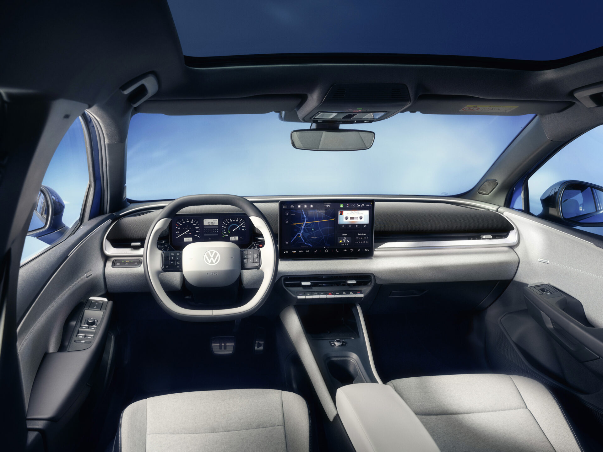 Interior de um carro da Volkswagen, com volante moderno, painel digital e tela de infotainment.