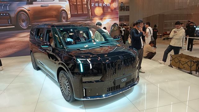 Veículo elétrico preto da marca Zeekr em uma exposição, com pessoas ao redor observando o carro.