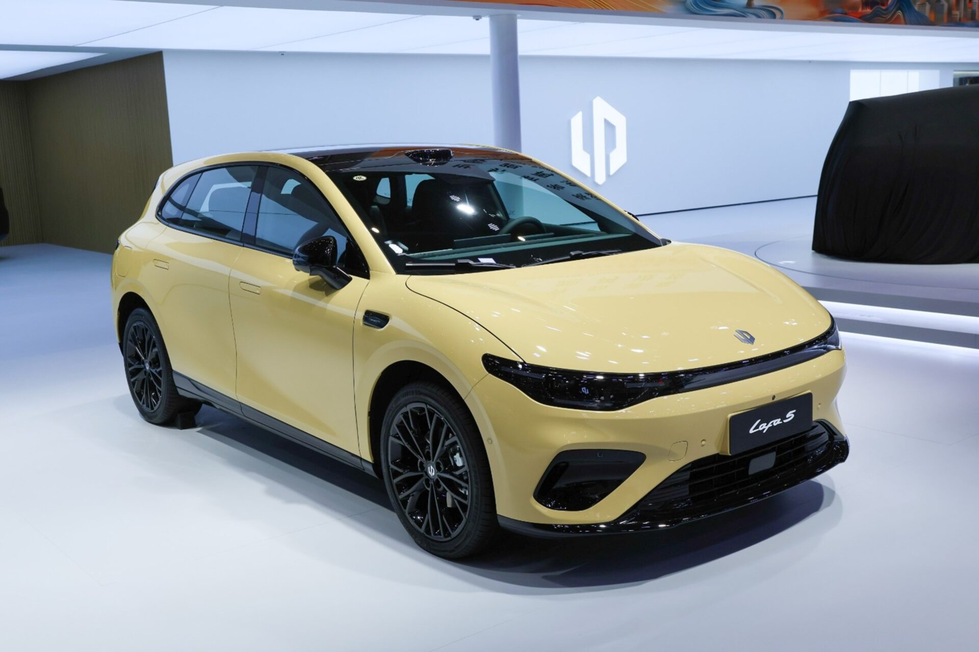 A modern yellow car displayed in an exhibition, featuring a sleek design and black accents, with the model name 'Lora S' visible on the front.