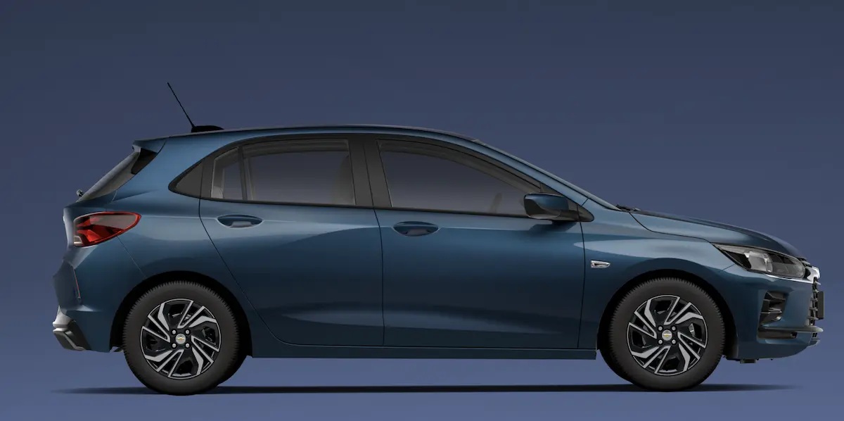 A side profile view of a blue hatchback car against a dark background.