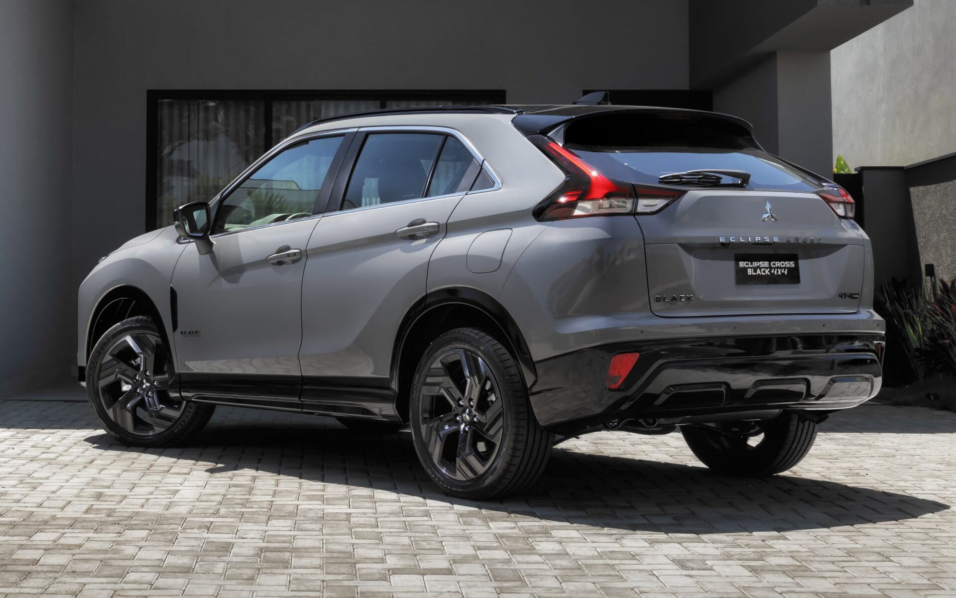 A Mitsubishi Eclipse Cross 4x4 parked on a cobblestone driveway, showcasing its sleek design and polished exterior.