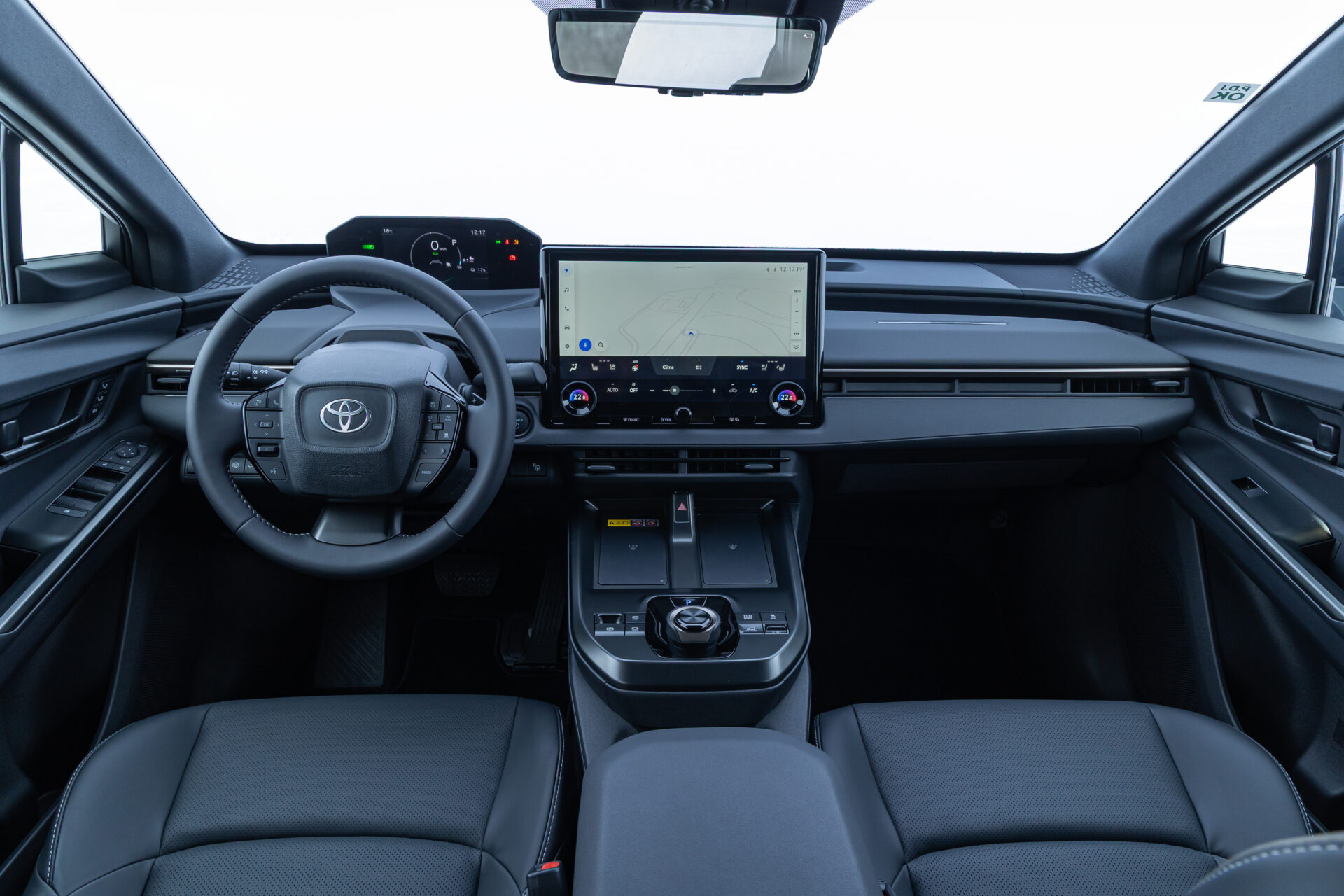 Interior view of a modern Toyota vehicle showcasing the steering wheel, dashboard display, and center console with touchscreen navigation.