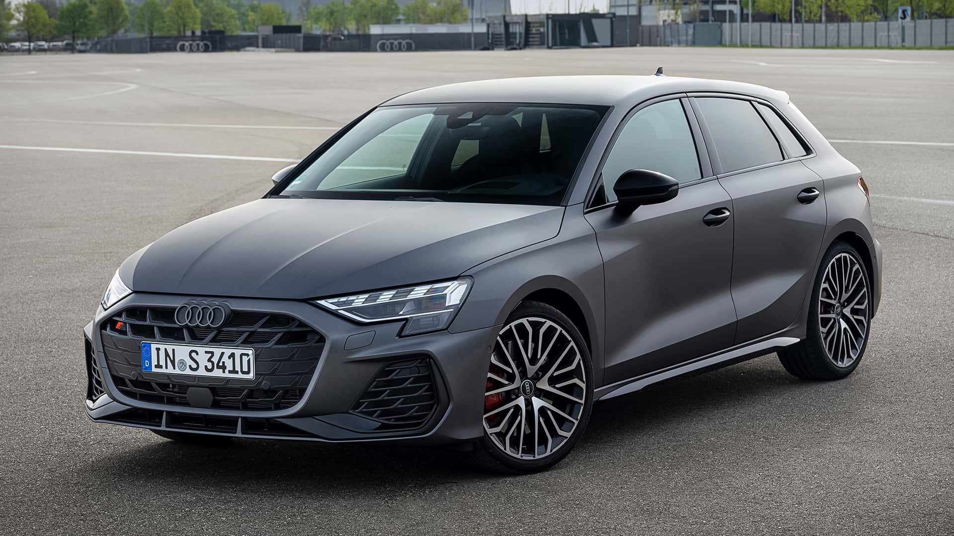 A sleek, gray Audi S3 hatchback parked on an asphalt surface, showcasing its modern design and sporty features.