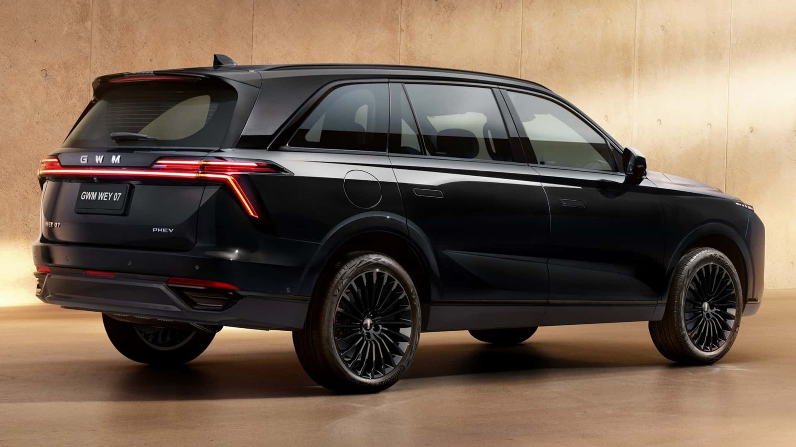A sleek black SUV, the GWM WEY 07, featured from a rear angle showcasing its modern design, stylish taillights, and black alloy wheels.